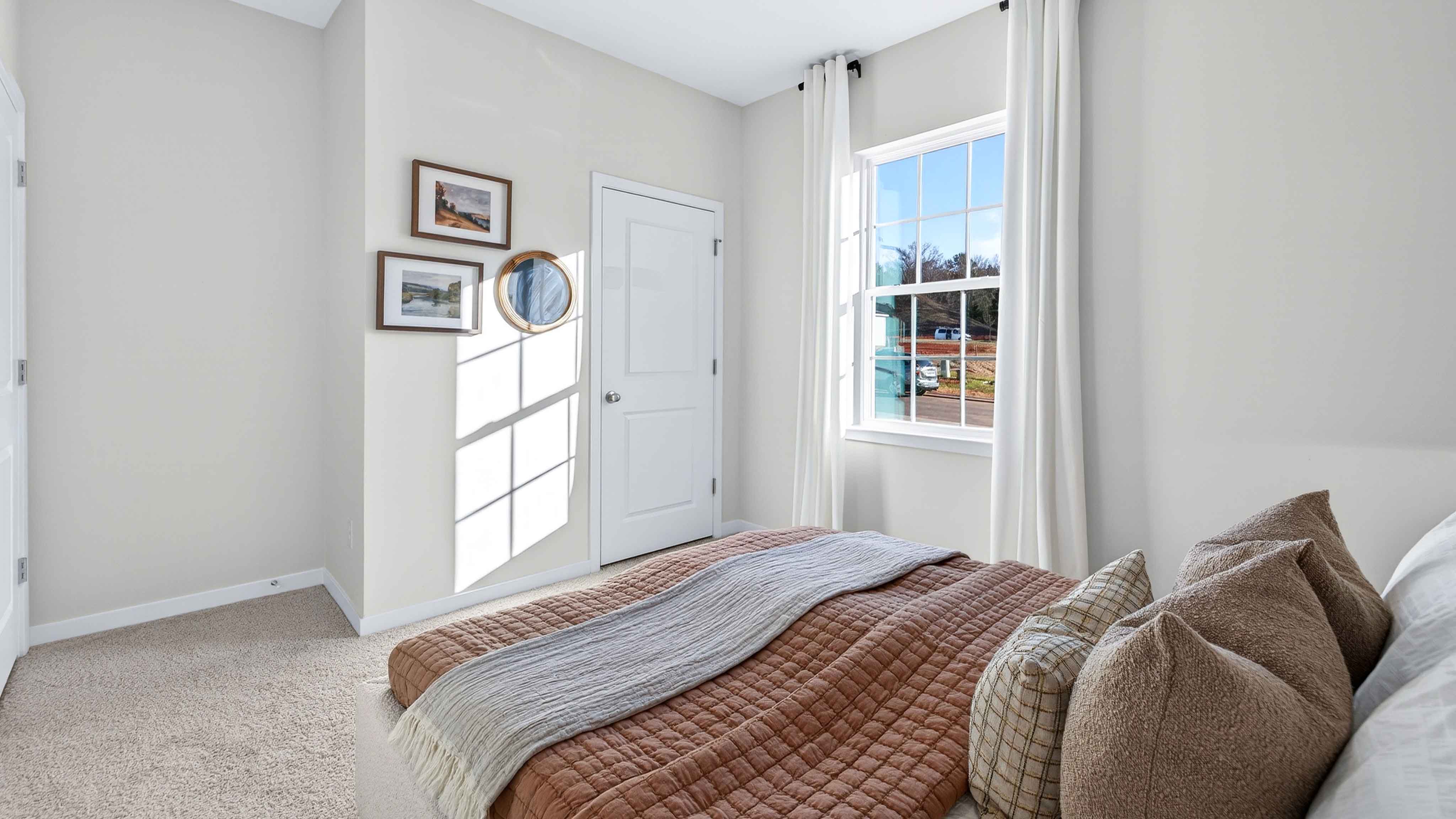 Carpeted bedroom with large window