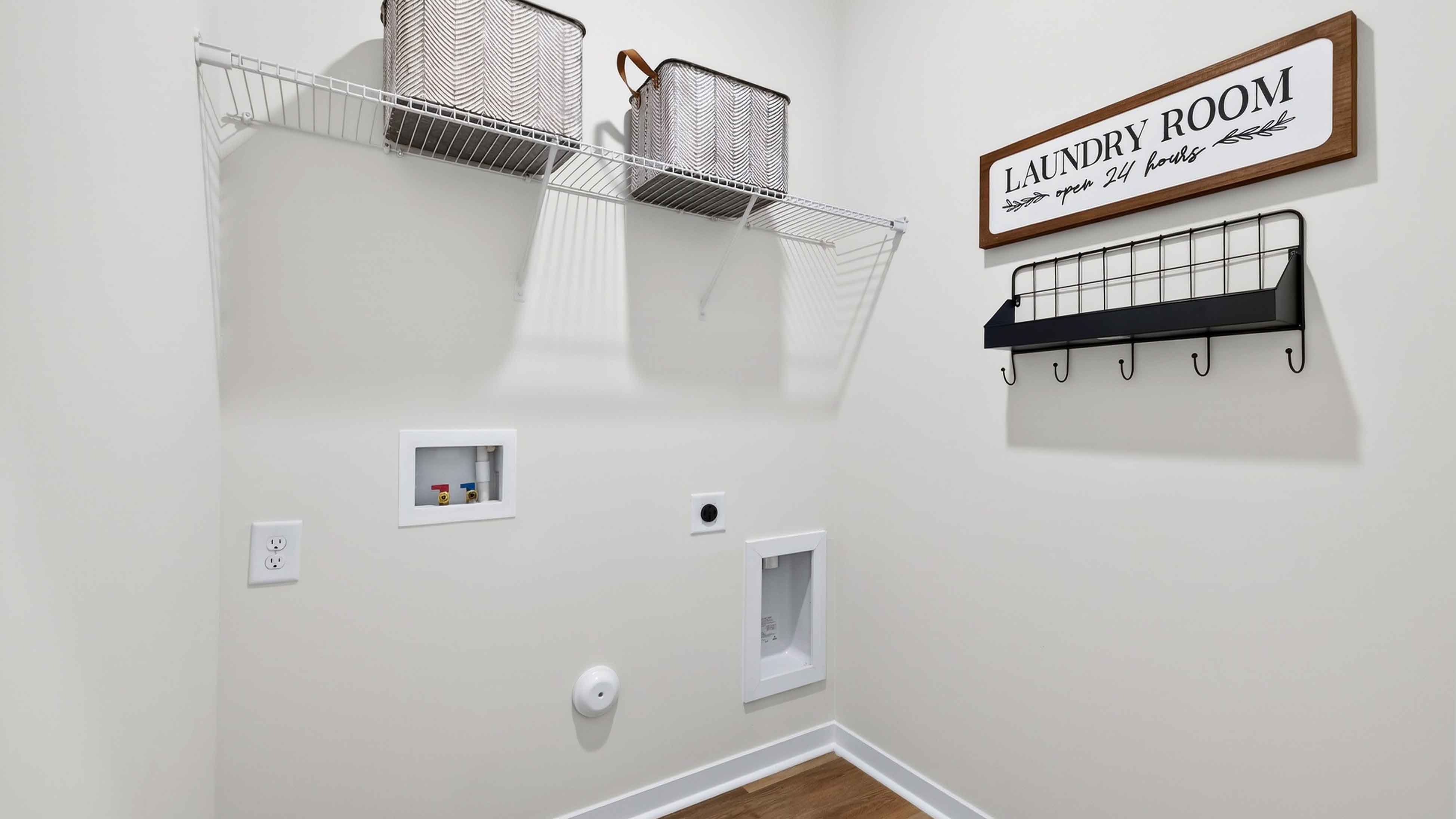 Laundry Room with racks above machines