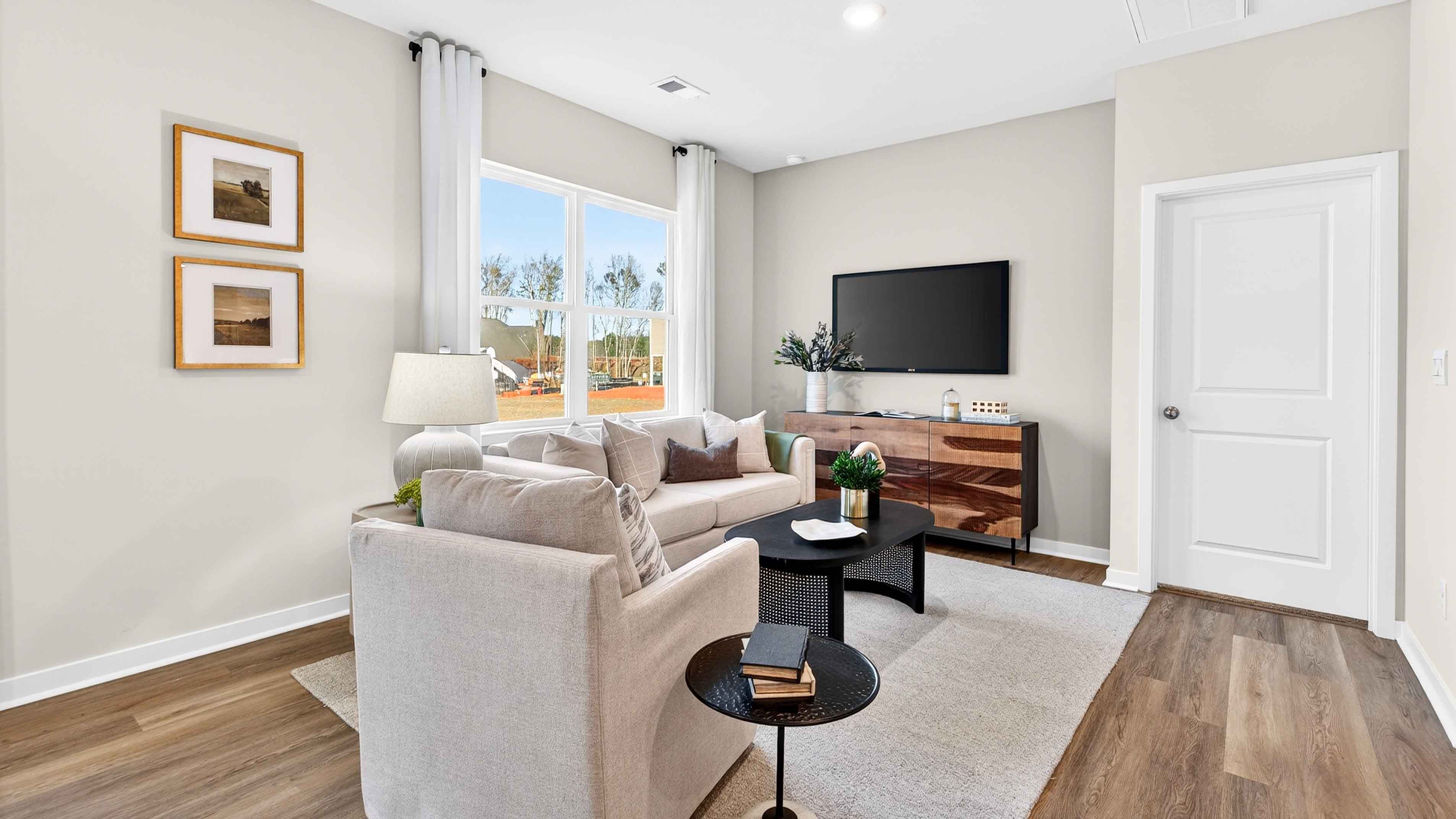 Great room with large window and wood floors