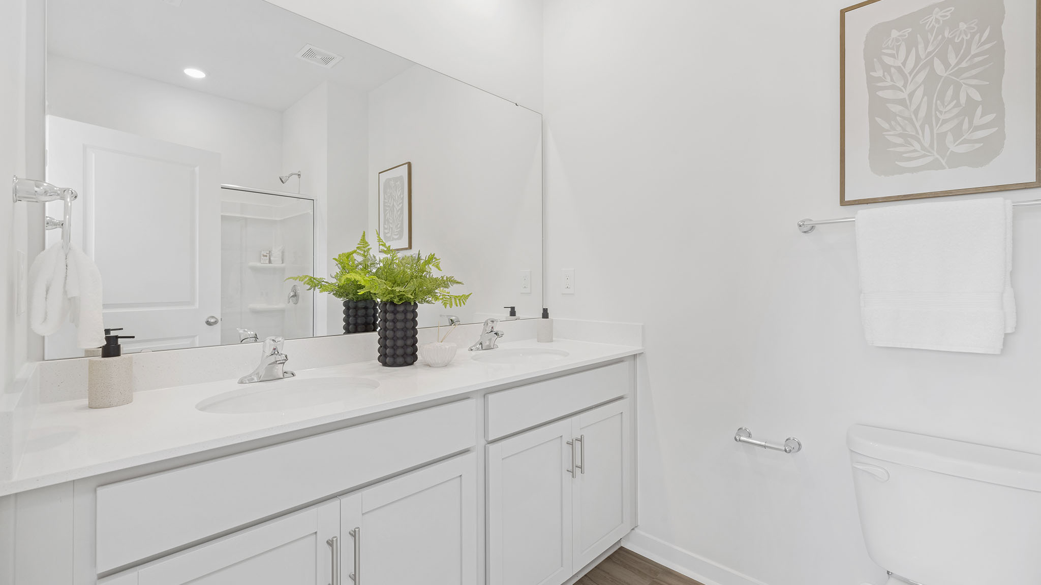 Primary bathroom with white cabinets