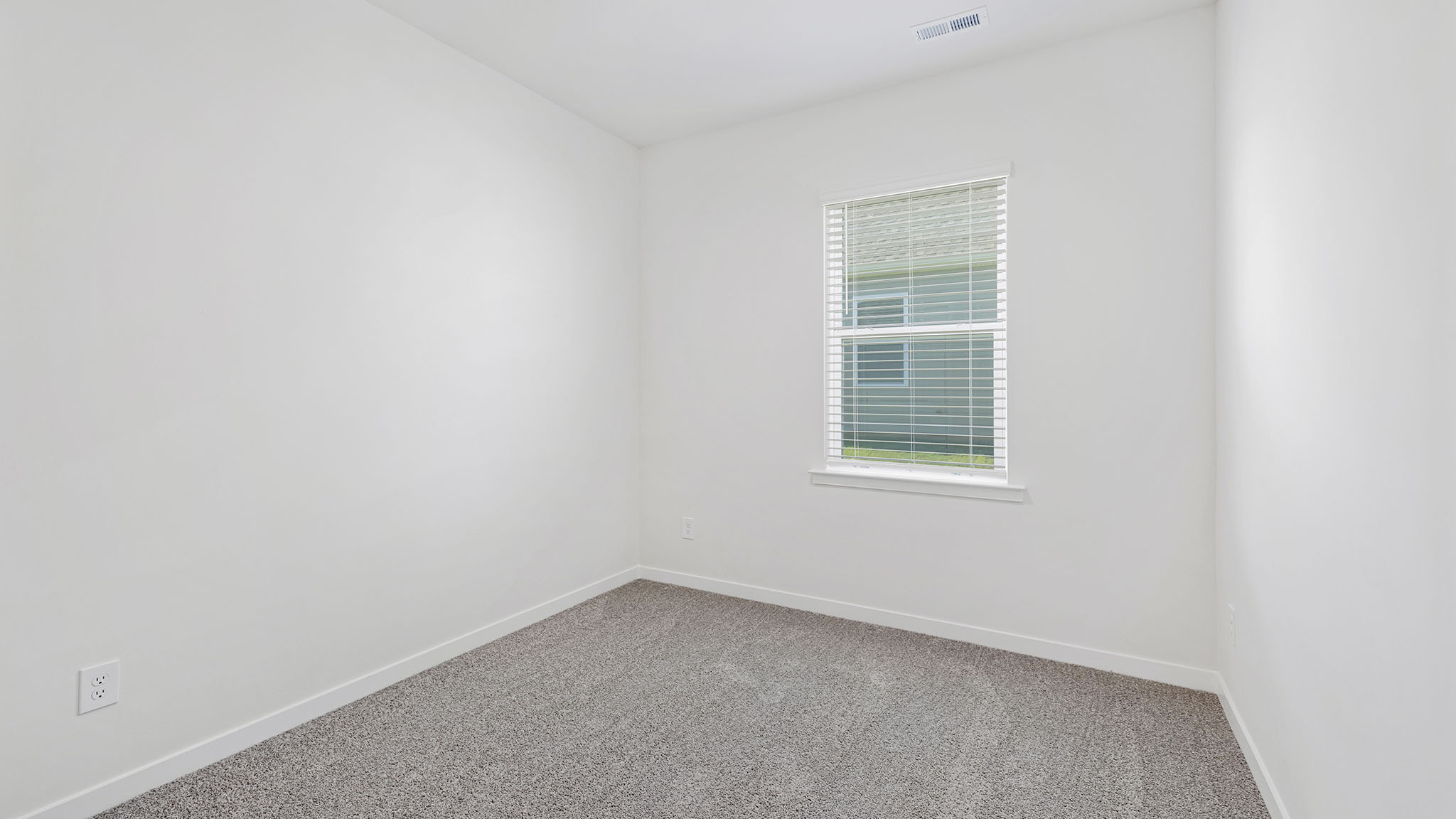 Carpeted bedroom with large window