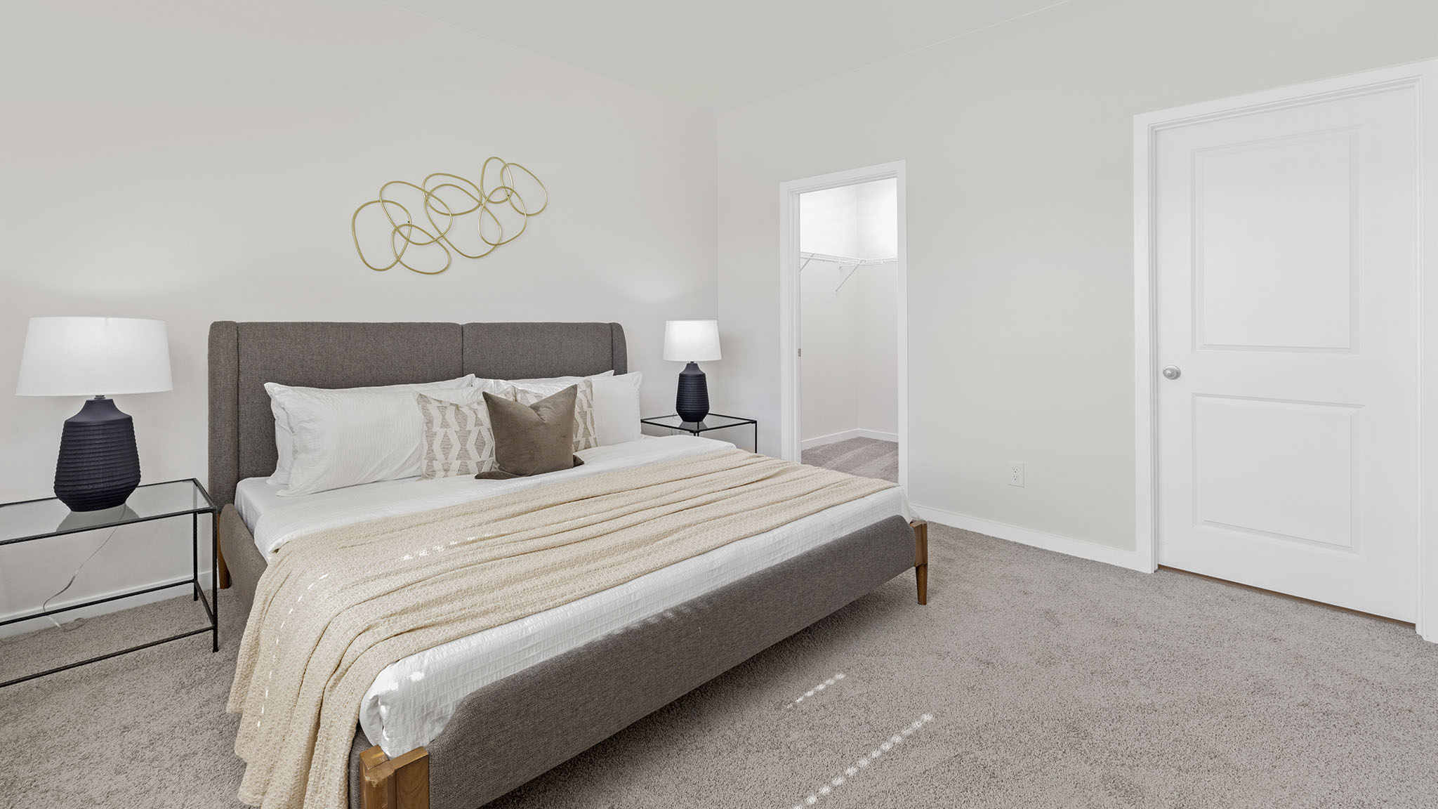 Primary carpeted bedroom with large window