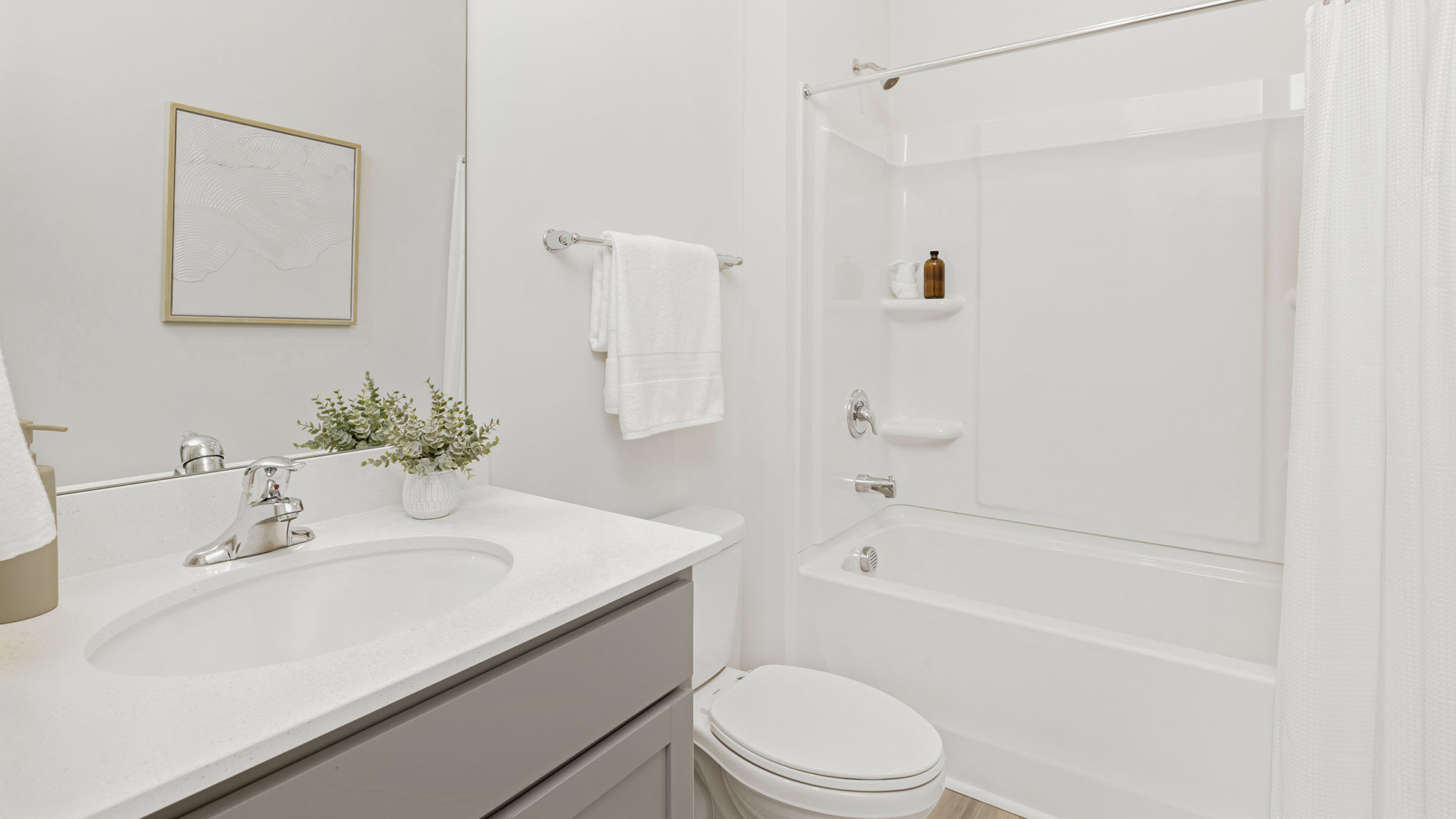 Bathroom with bathtub, white counters and cabinets