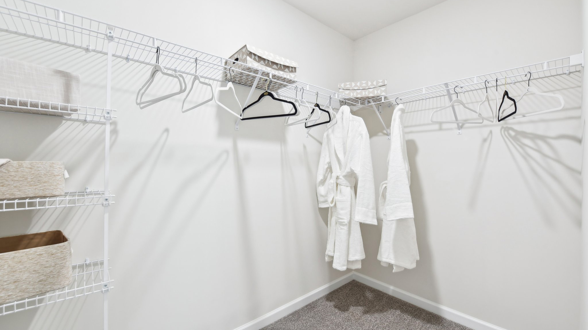 Primary bedroom walk in closet