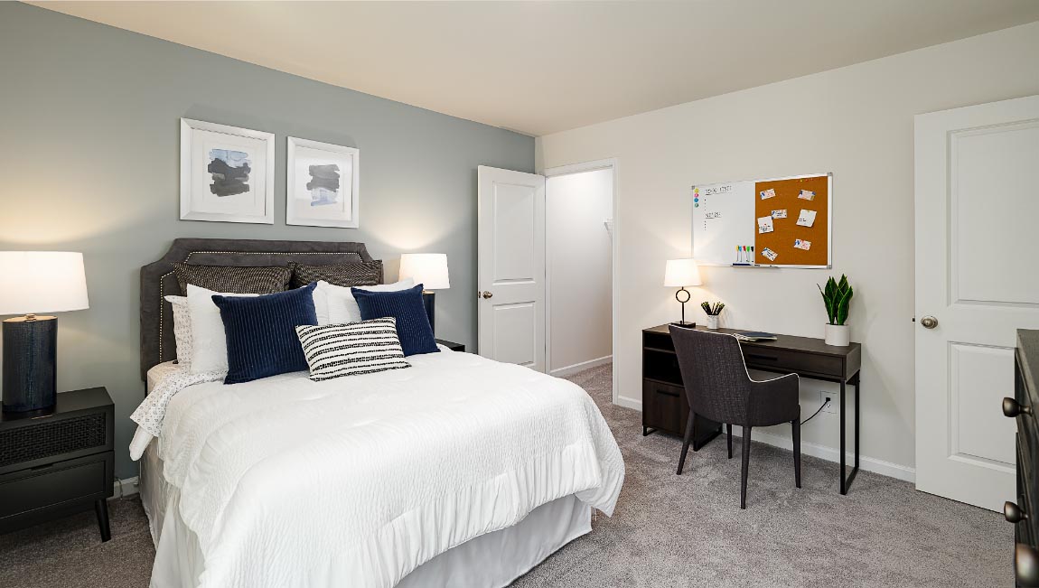 Carpeted bedroom with large window