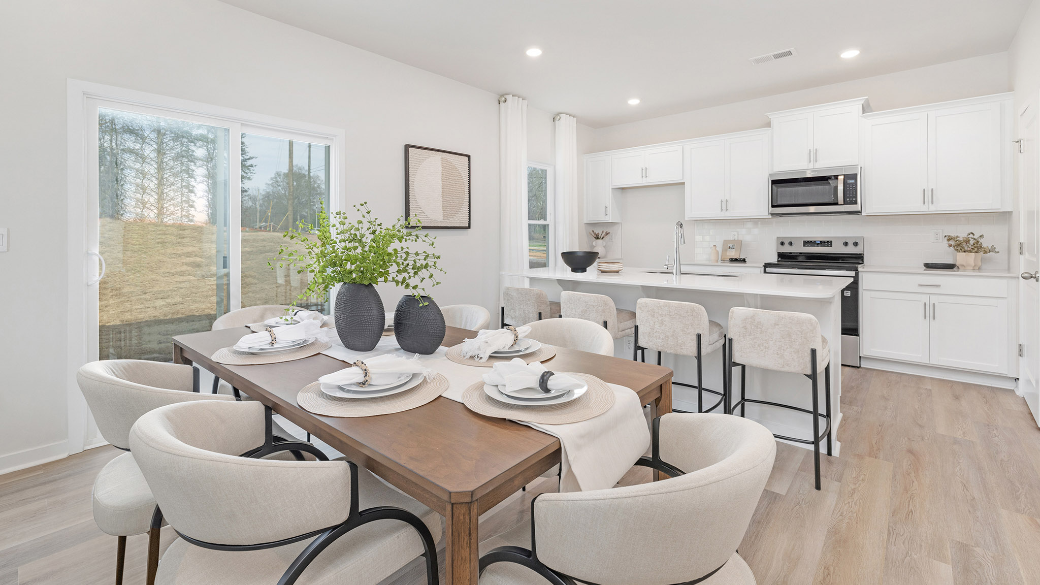 Open family room with fire place, vinyl floors, and large window