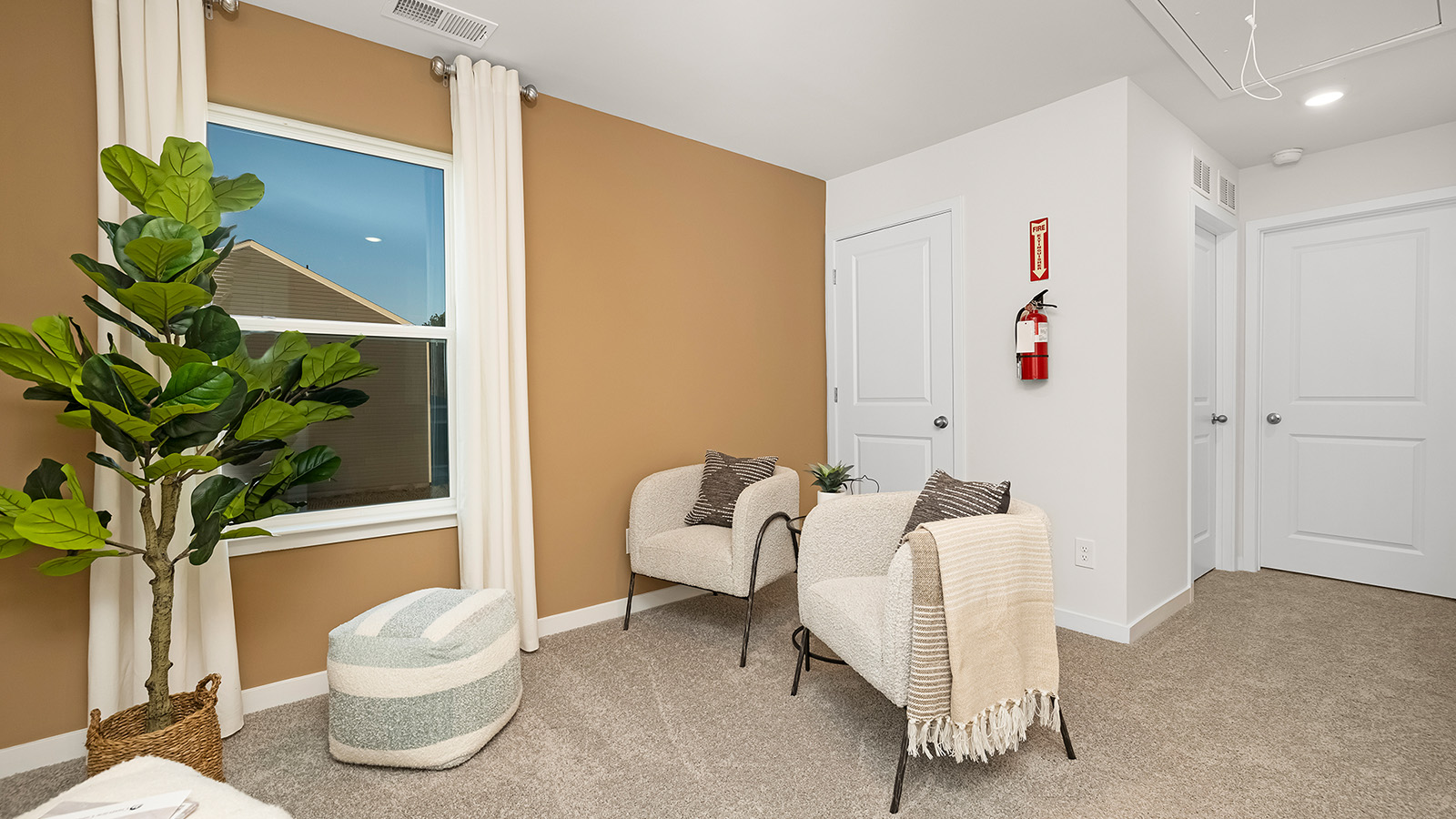 Carpeted loft space a top of the stairs
