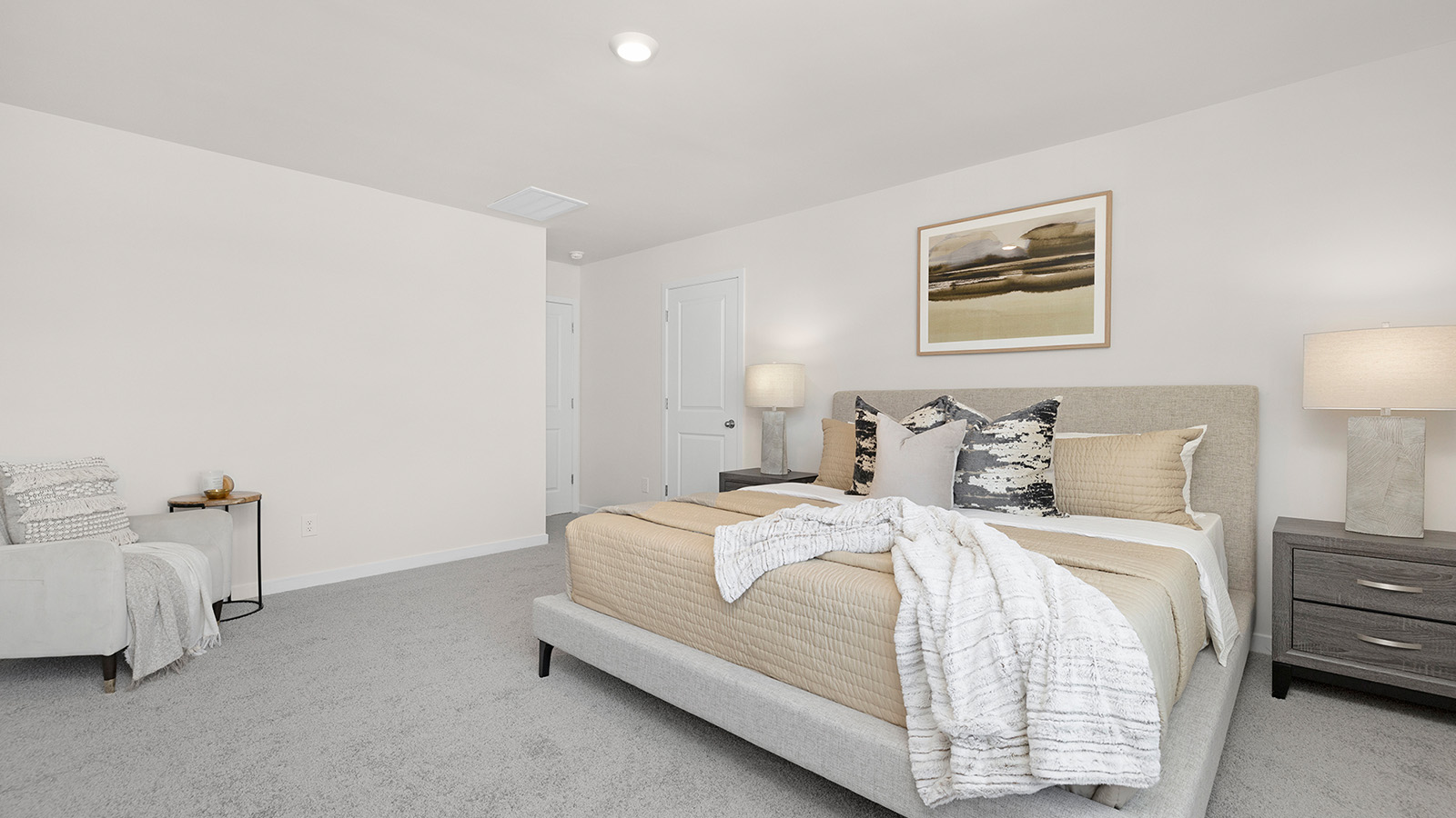 Carpeted primary bedroom with large windows