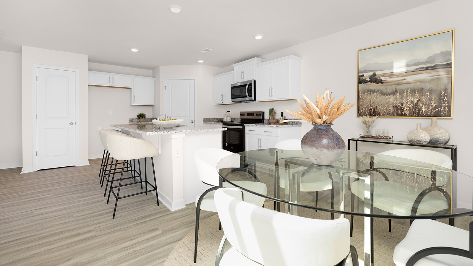 Kitchen and island with white cabinets and stainless steel appliances