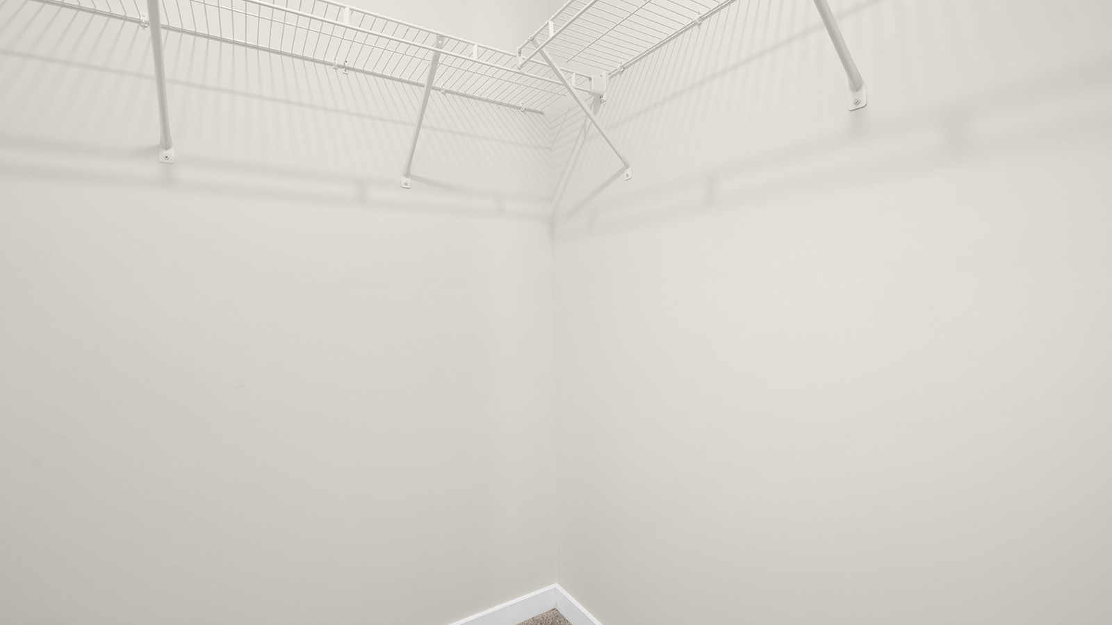 Laundry room with over the machine racks for storage