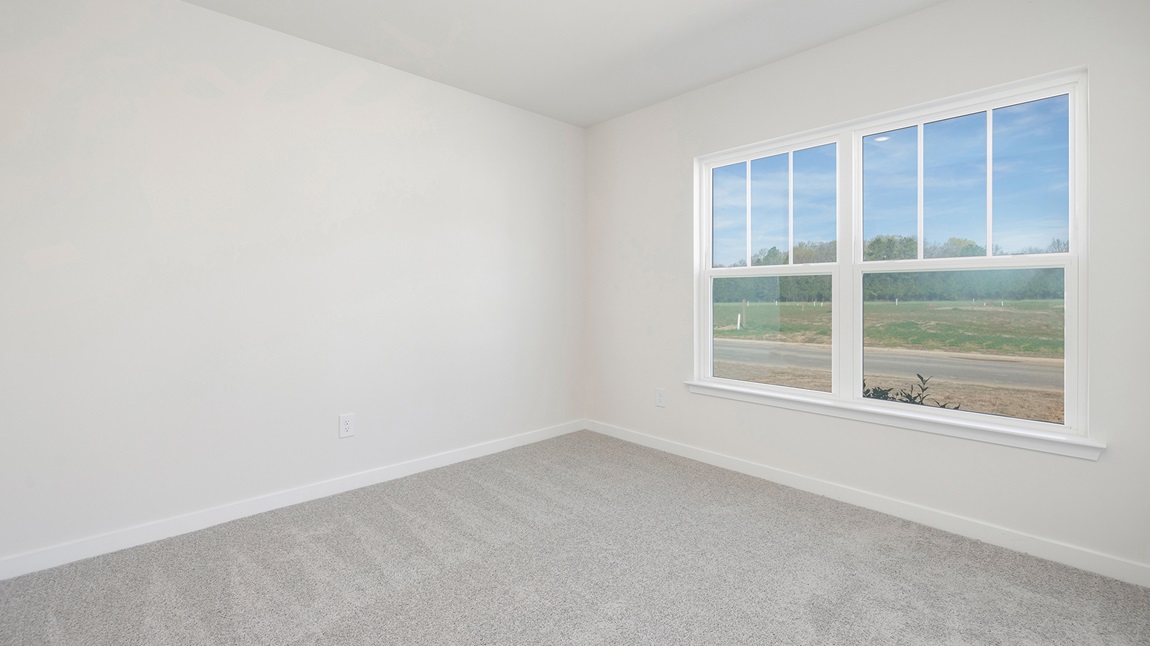 Carpeted bedroom with large window