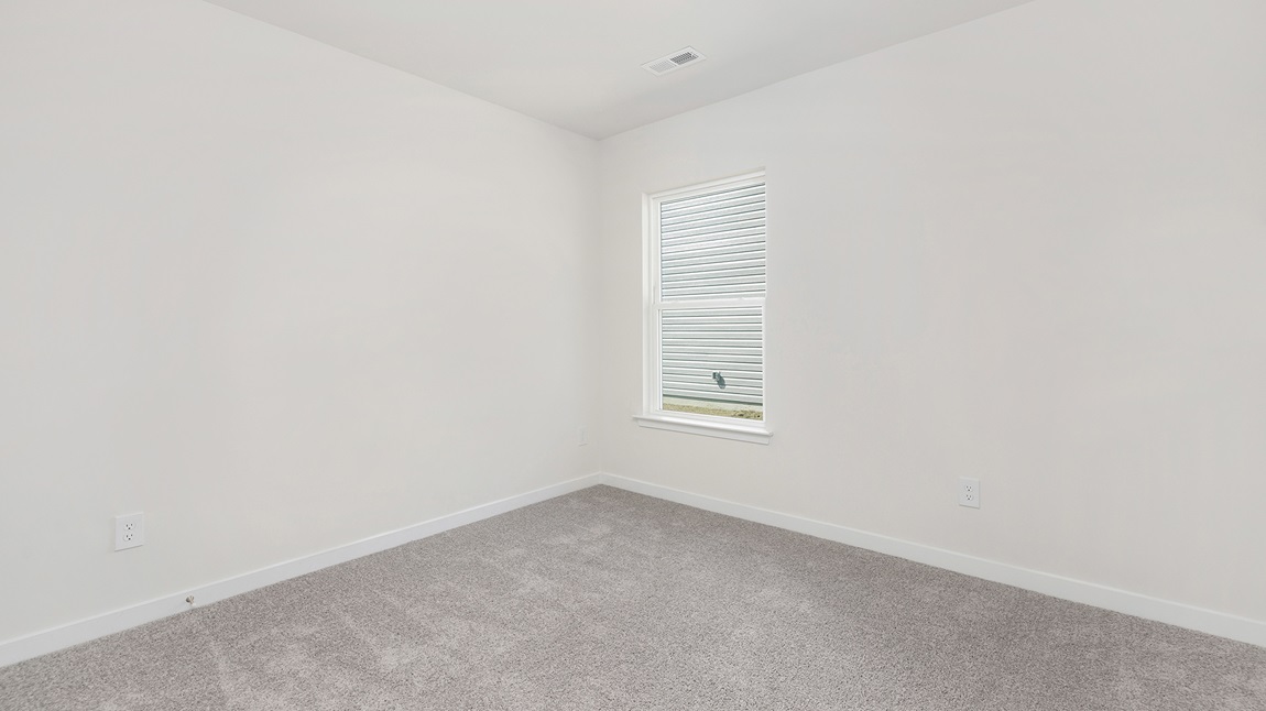 Carpeted bedroom with large window