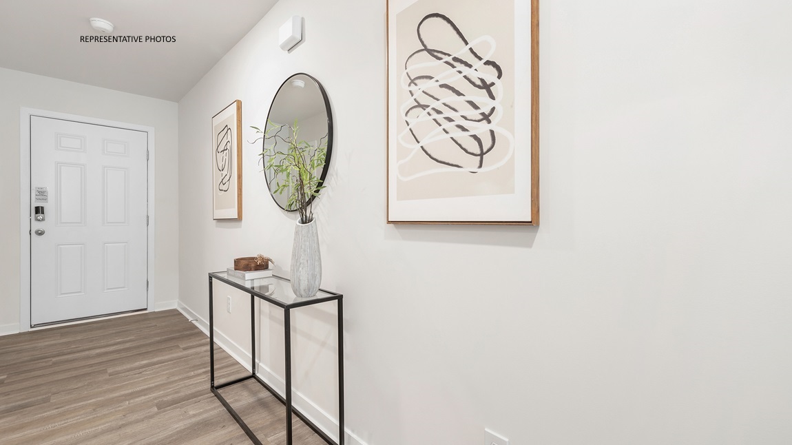 Welcoming foyer with wood floors