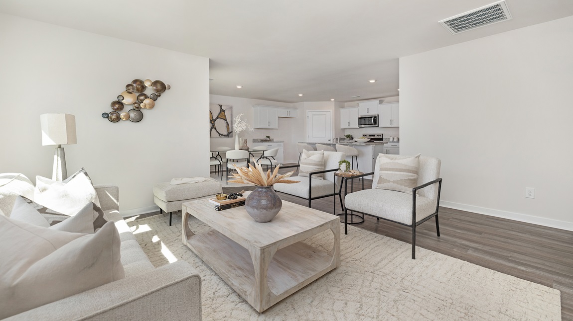 Living room with large windows beside kitchen