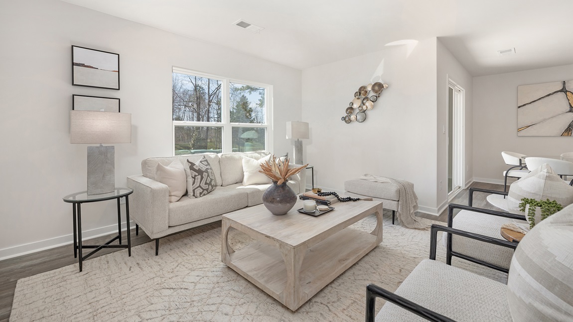 Living room with large windows beside kitchen