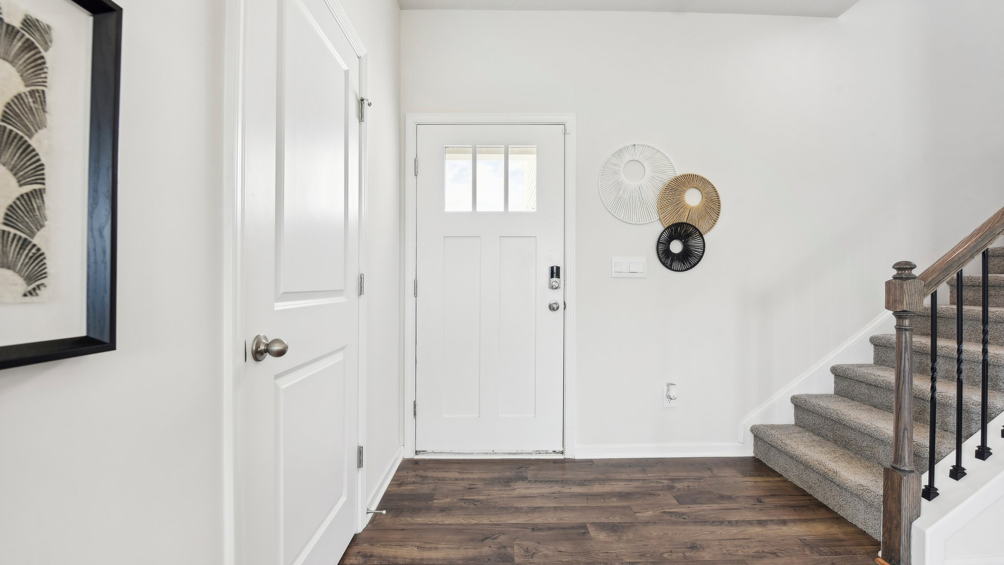 Welcoming foyer with view of front door and stairs