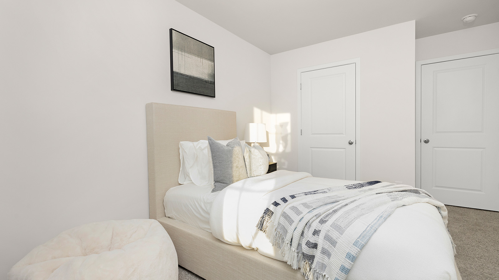 Carpeted bedroom with small window