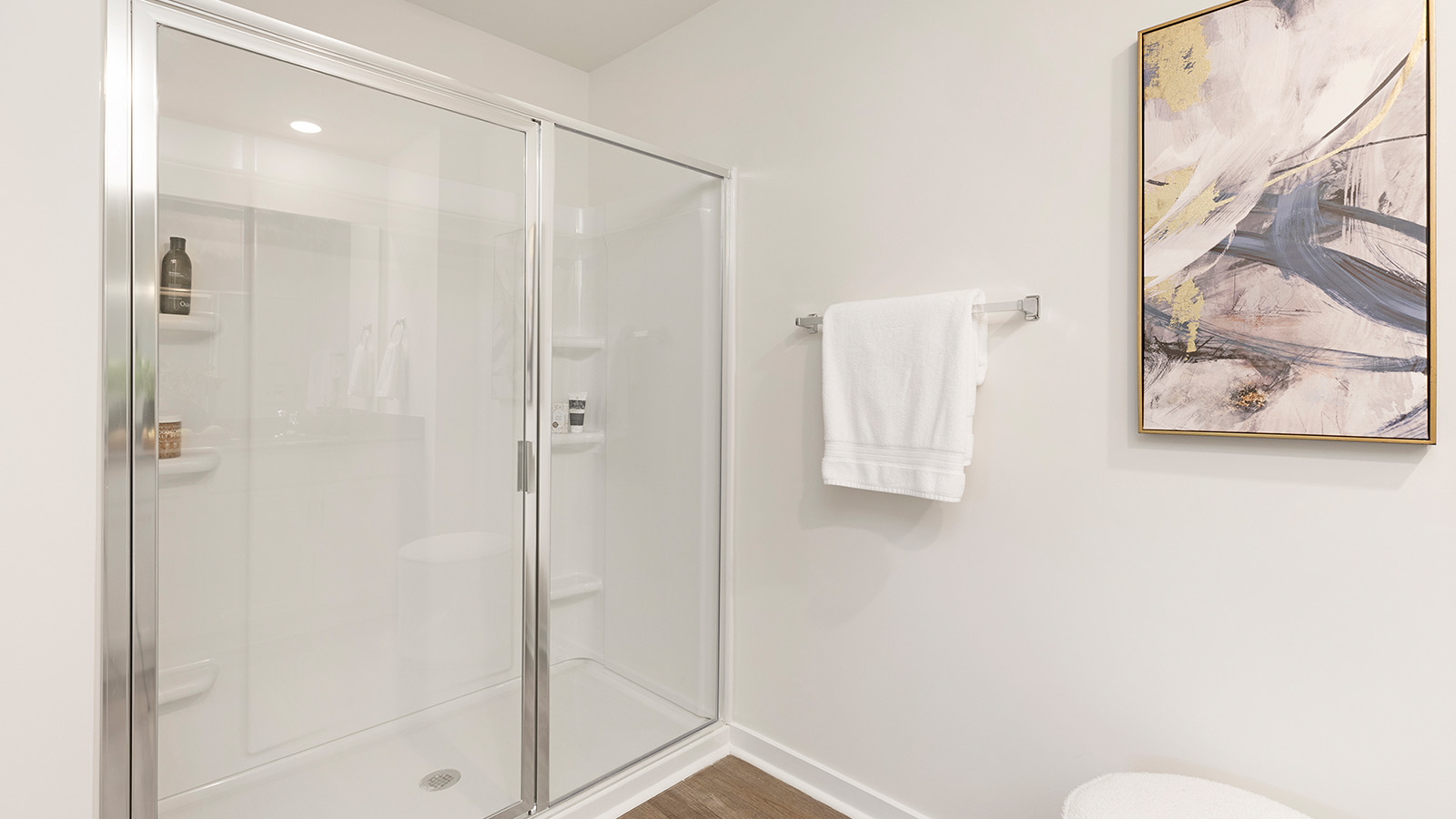 Primary bathroom with double sinks, white cabinets and counters
