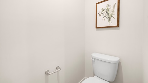 Primary bathroom with double vanity and glass door shower