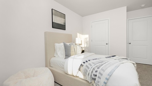 Carpeted bedroom with small window