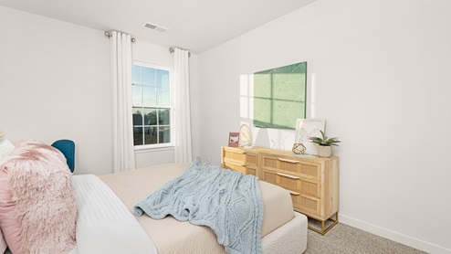 Carpeted bedroom with small window