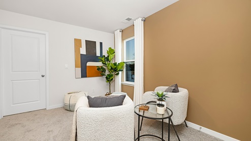 Open space carpeted loft area with large window