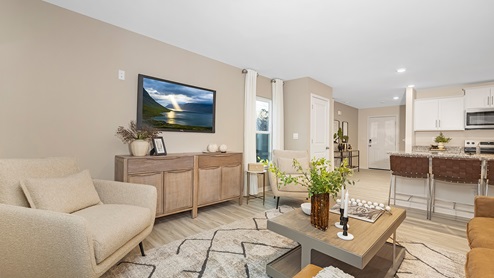 Open family room with large window off of kitchen