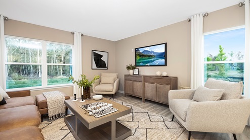 Open family room with large window off of kitchen