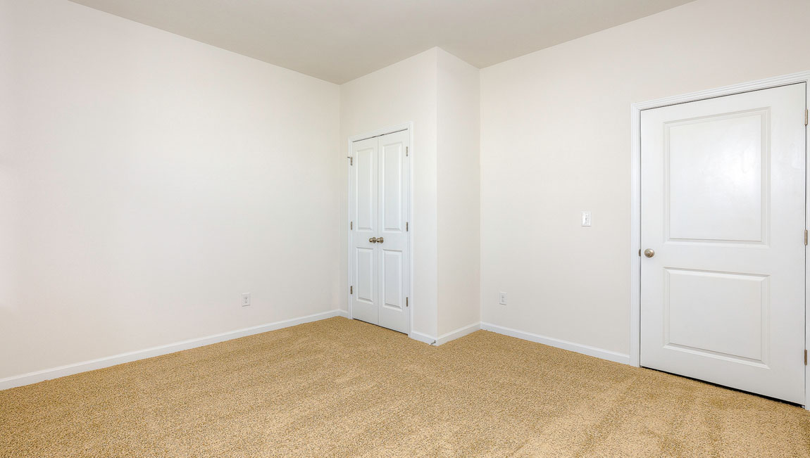 Carpeted bedroom with windows