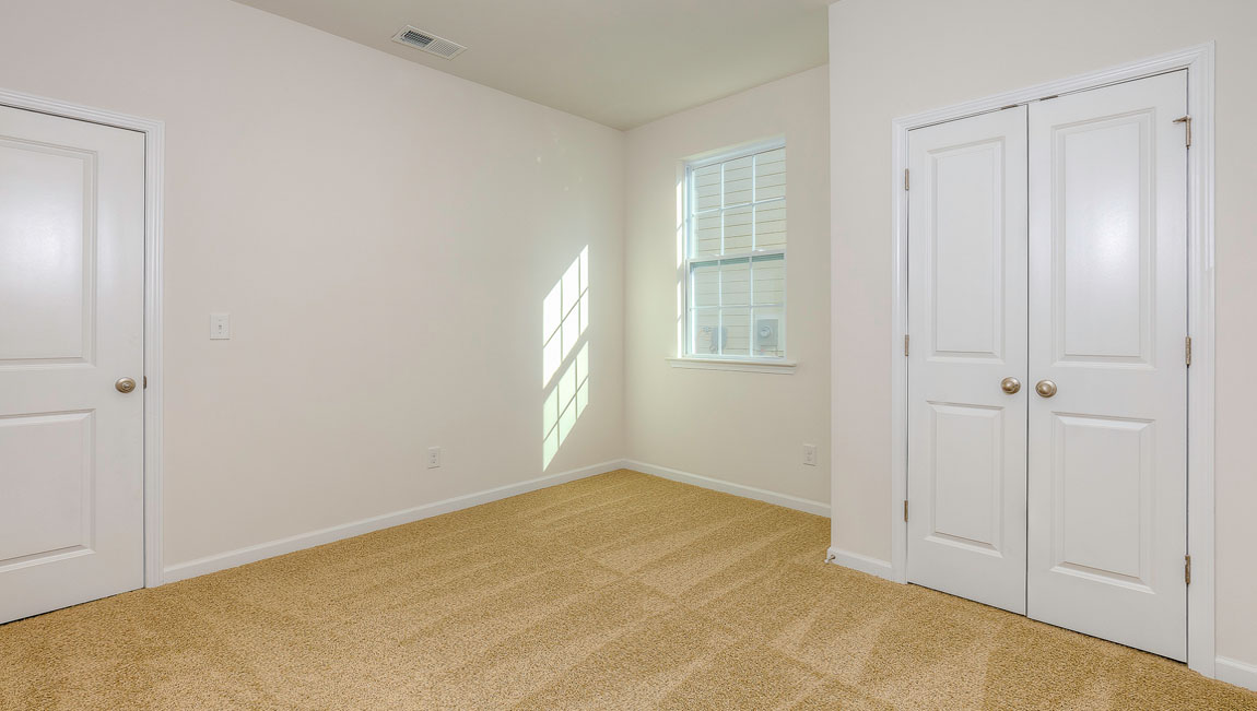 Carpeted bedroom with windows