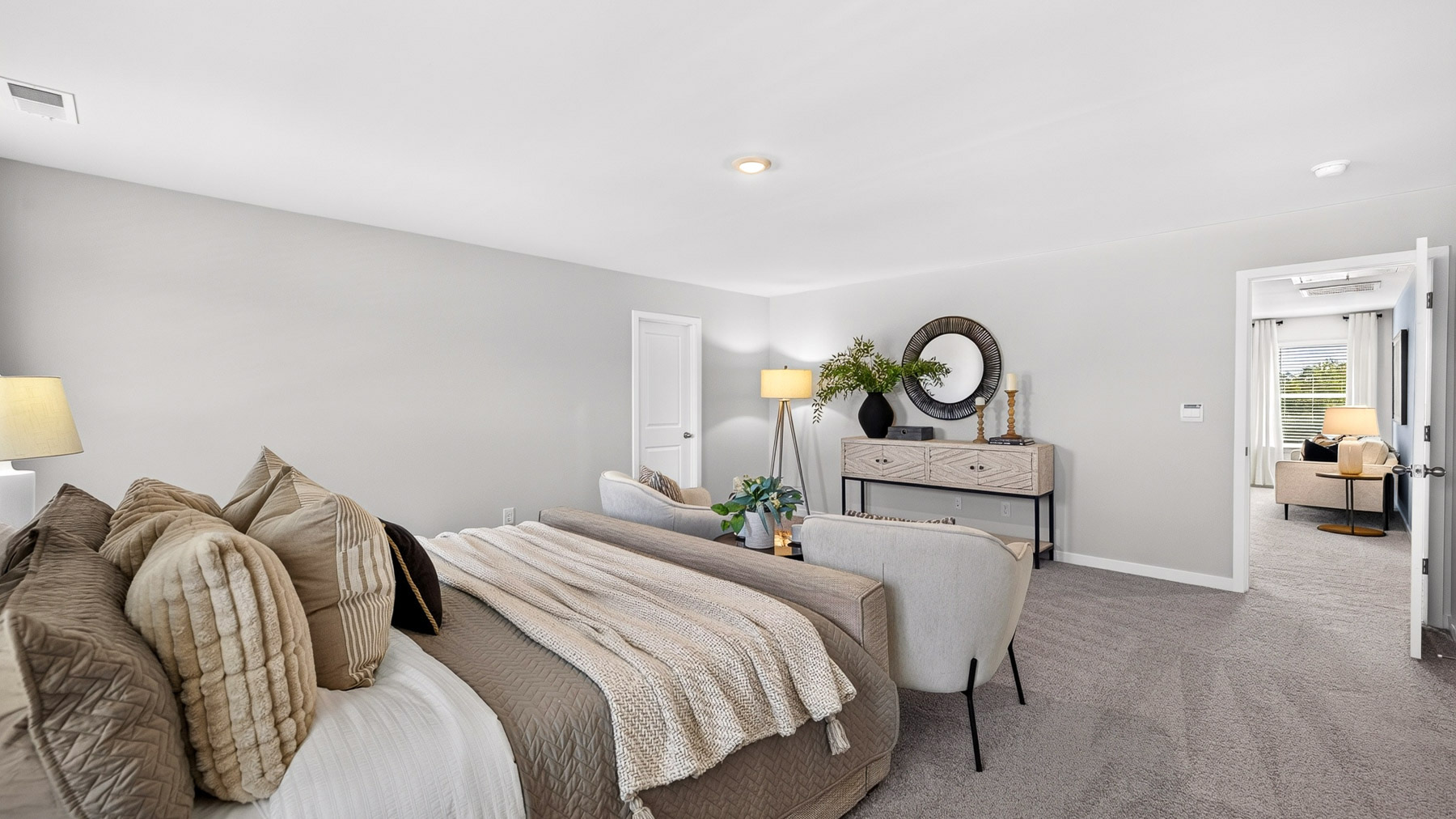 Primary carpeted bedroom with windows