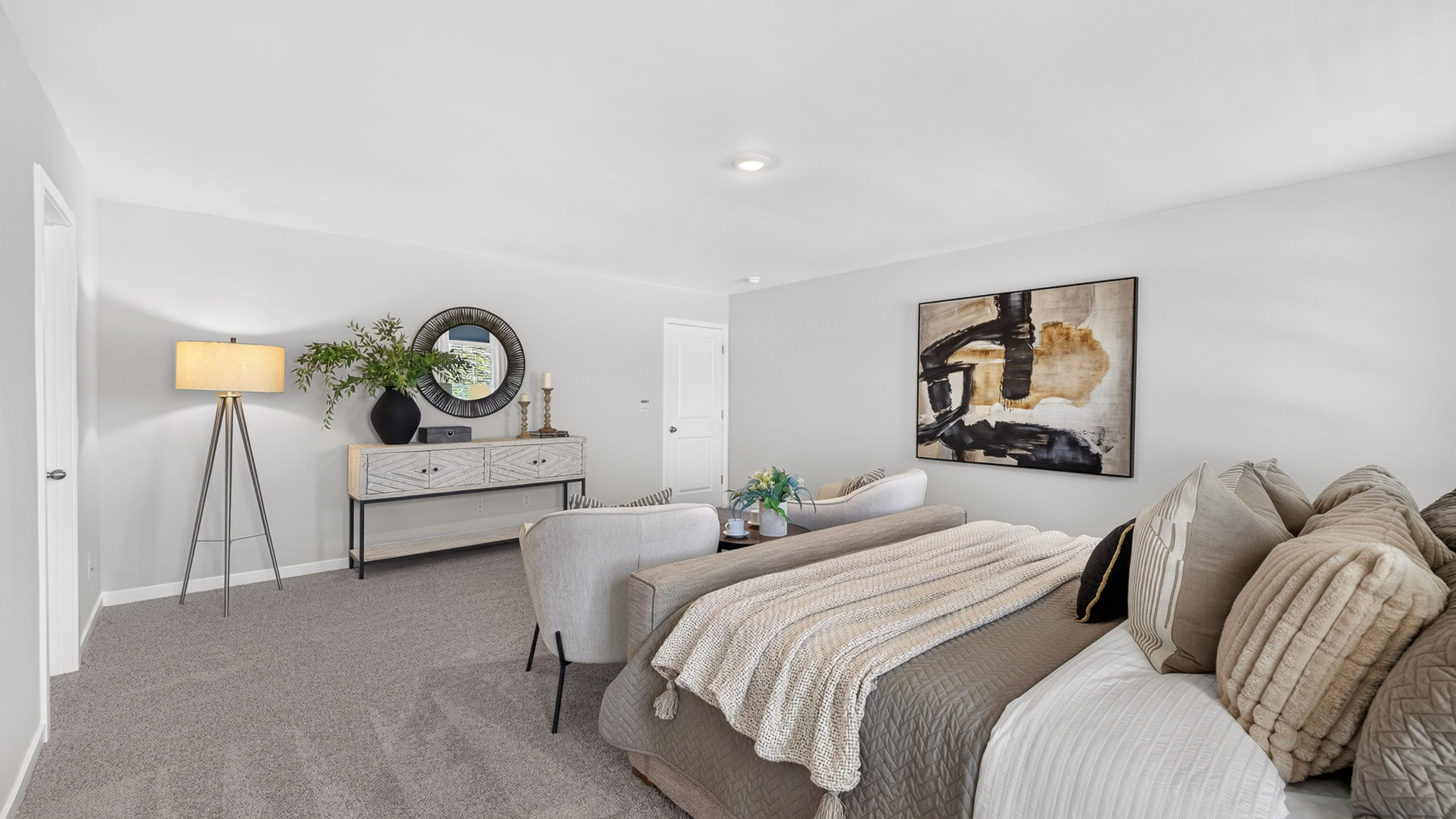 Primary carpeted bedroom with windows