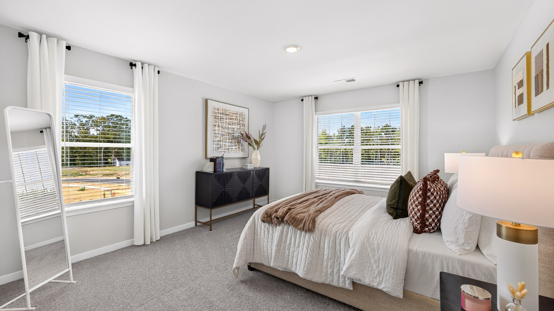 Carpeted bedroom with windows
