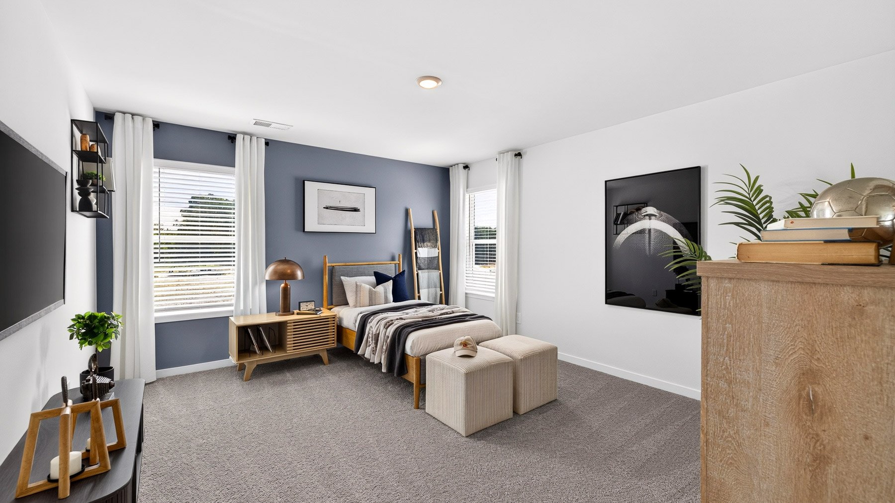 Carpeted bedroom with windows