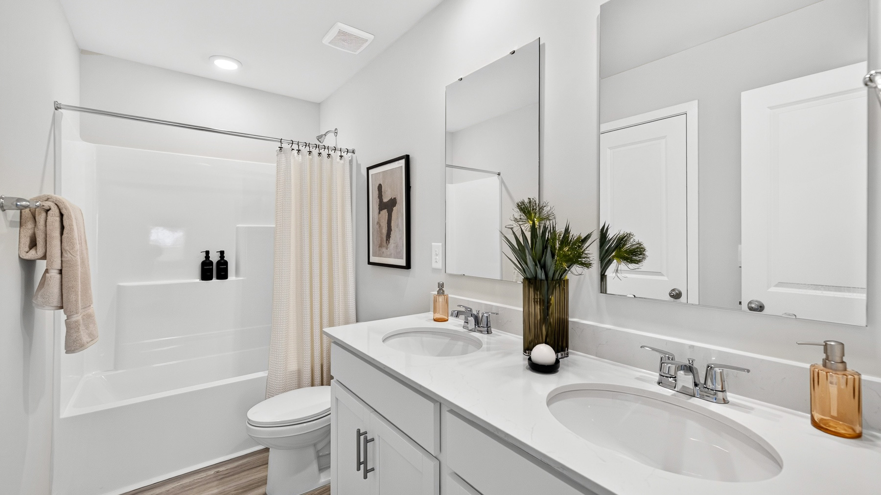 Bathroom with double sinks and standing tub shower