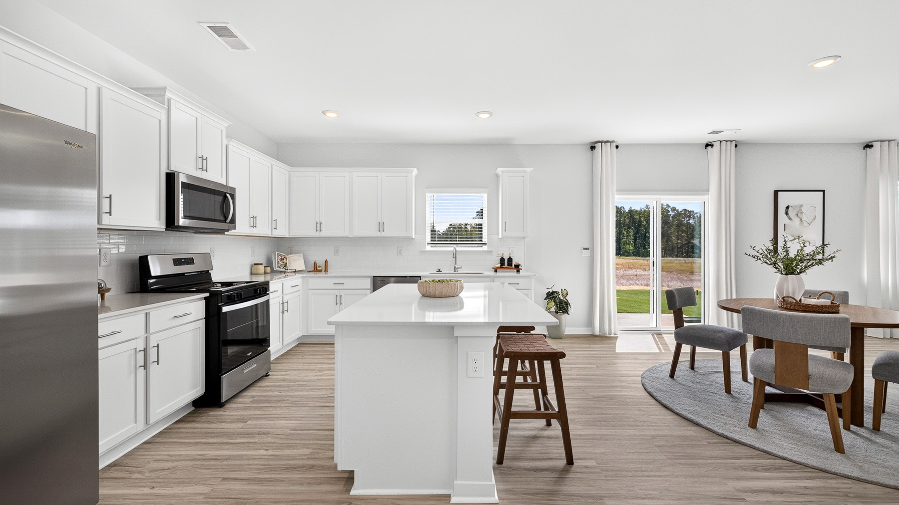 Kitchen and island with stainless steel appliances