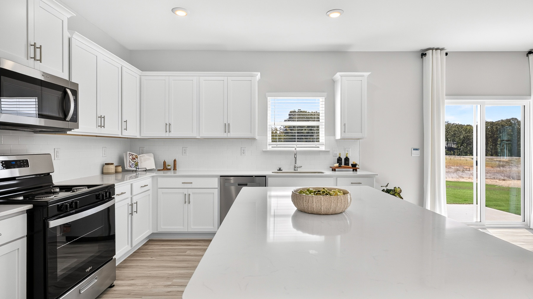 Kitchen and island with stainless steel appliances