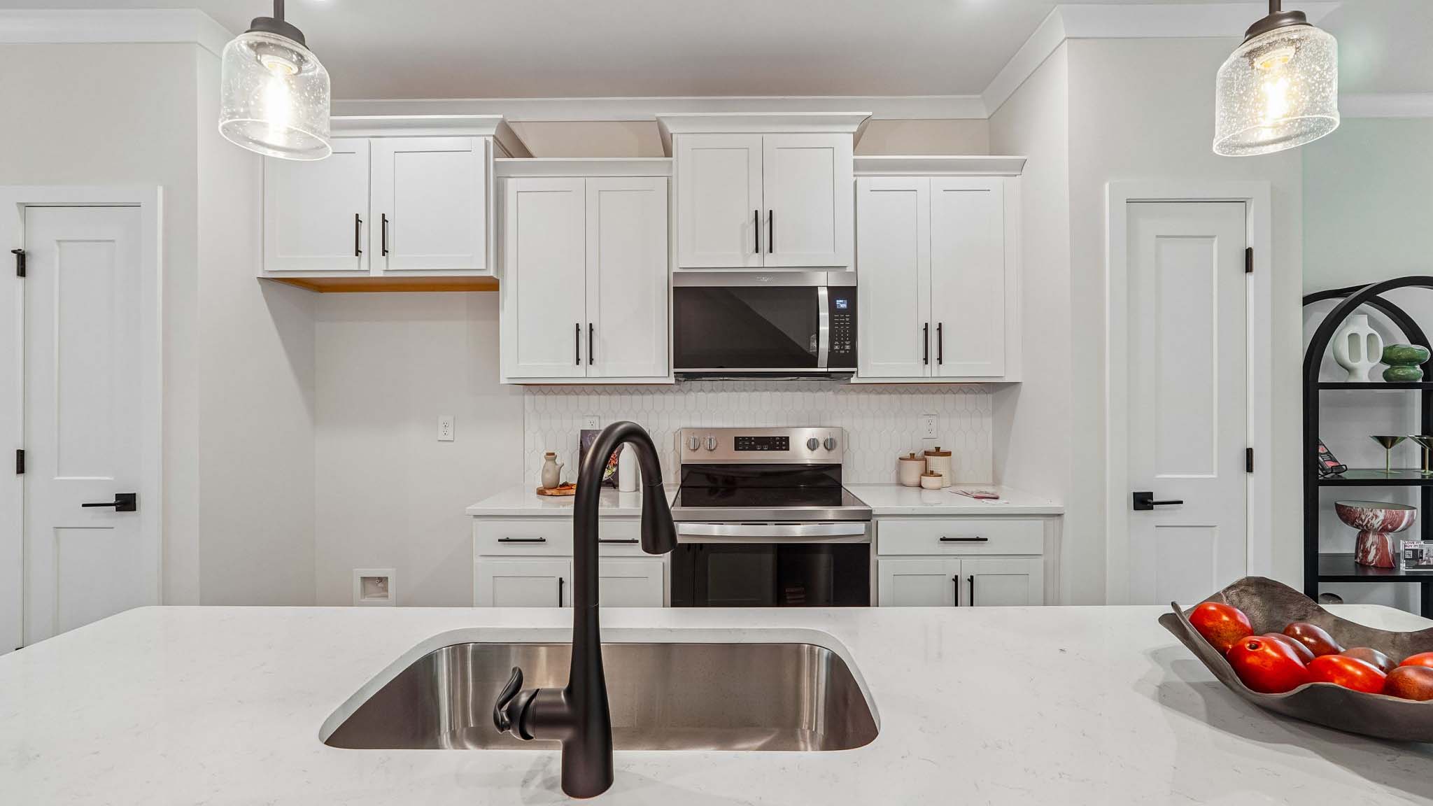 Kitchen and island with white cabinets