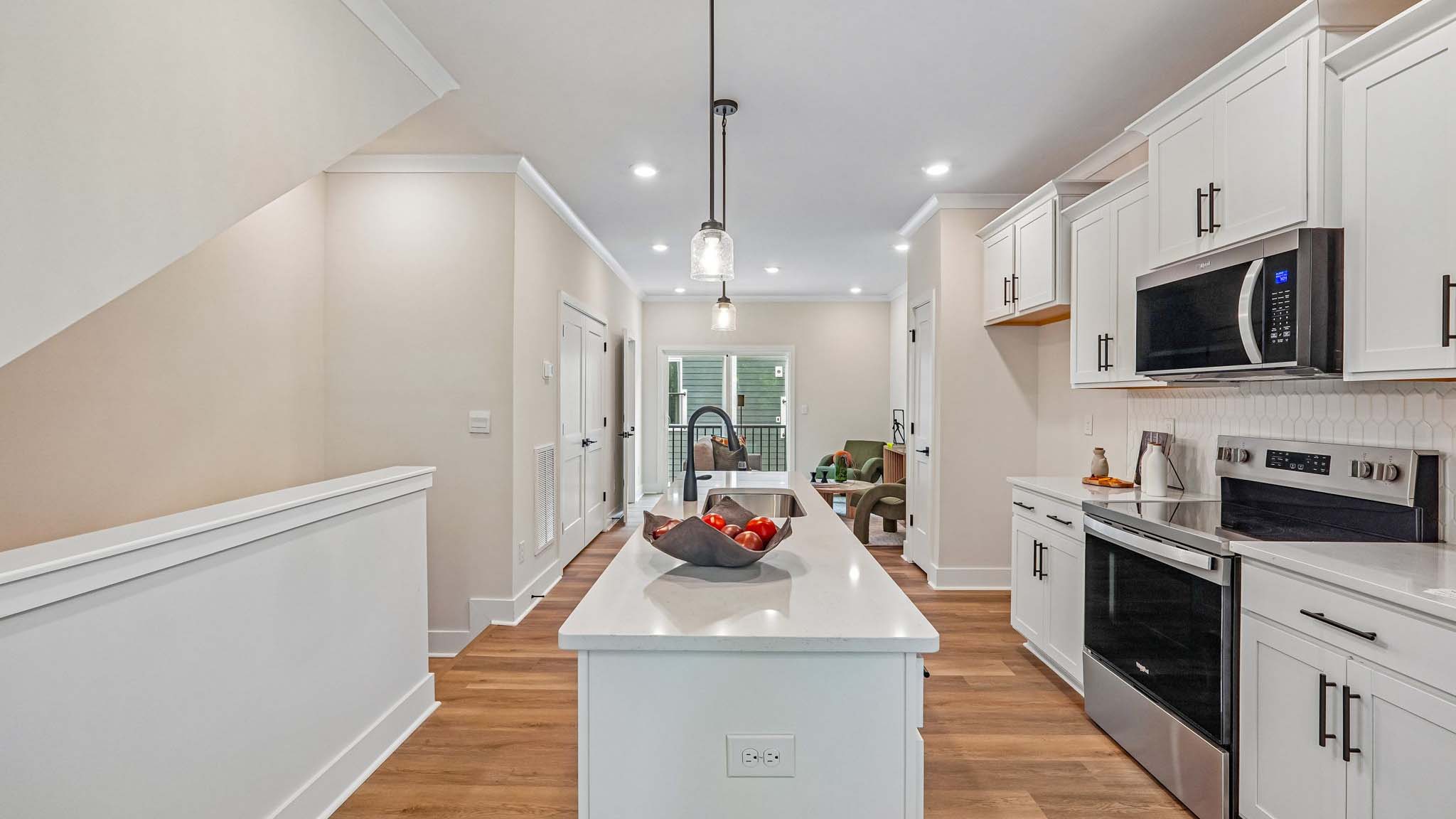 Kitchen and island with white cabinets
