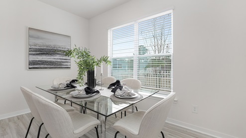 Dining area off of kitchen with large window