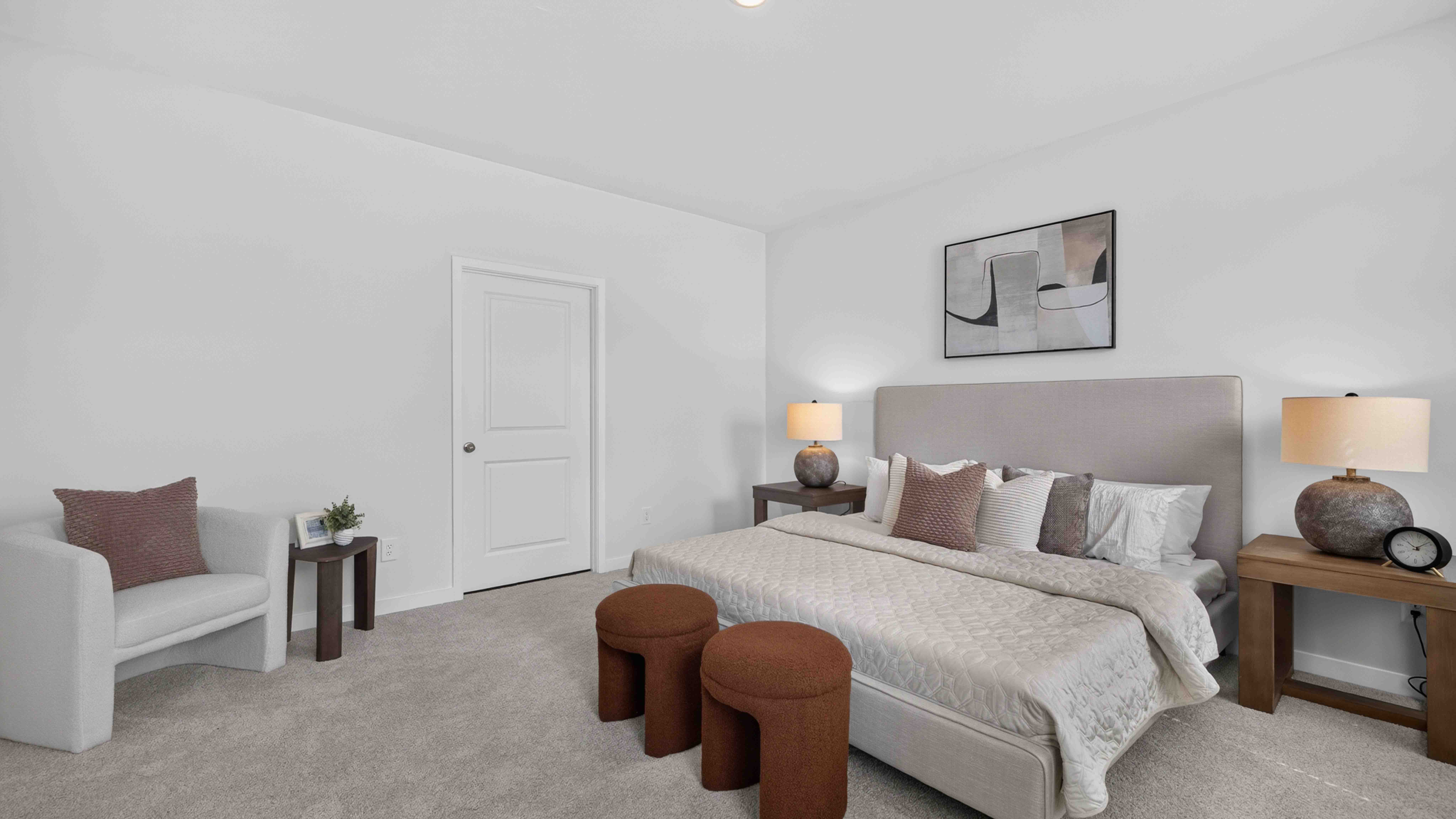Primary carpeted bedroom with windows