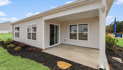 Exterior home with patio area.