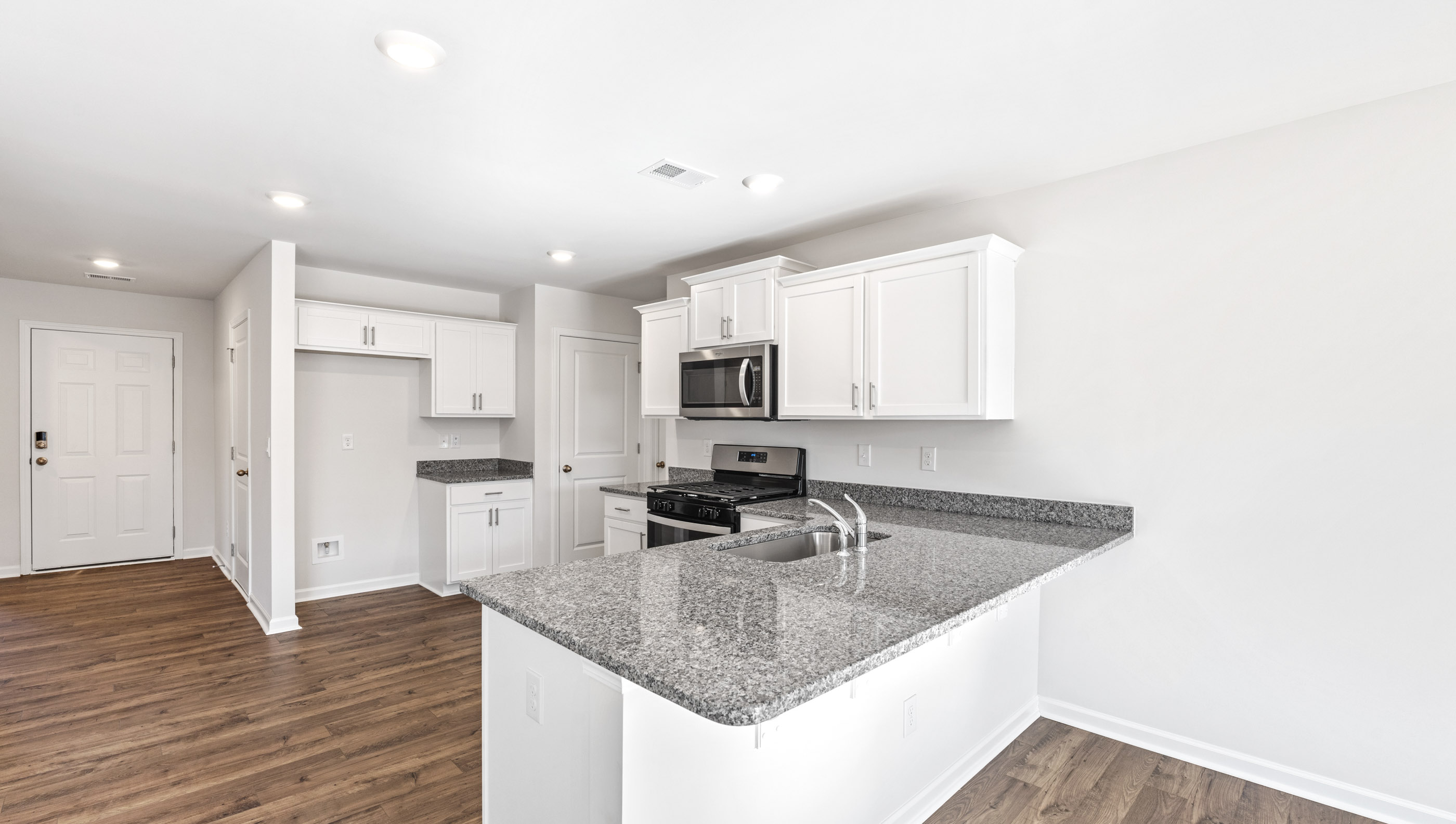 Kitchen with granite countertops and stainless steel appliances.