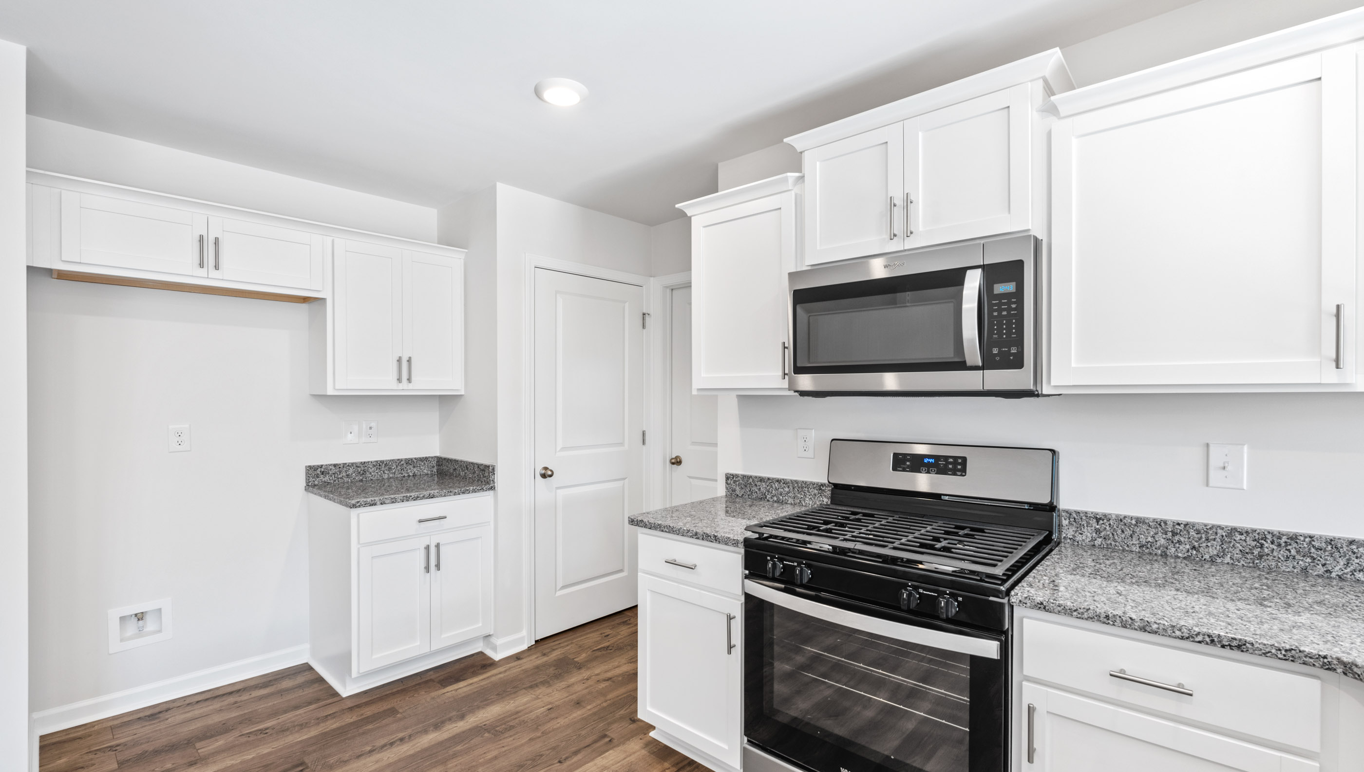 Kitchen with granite countertops and stainless steel appliances.