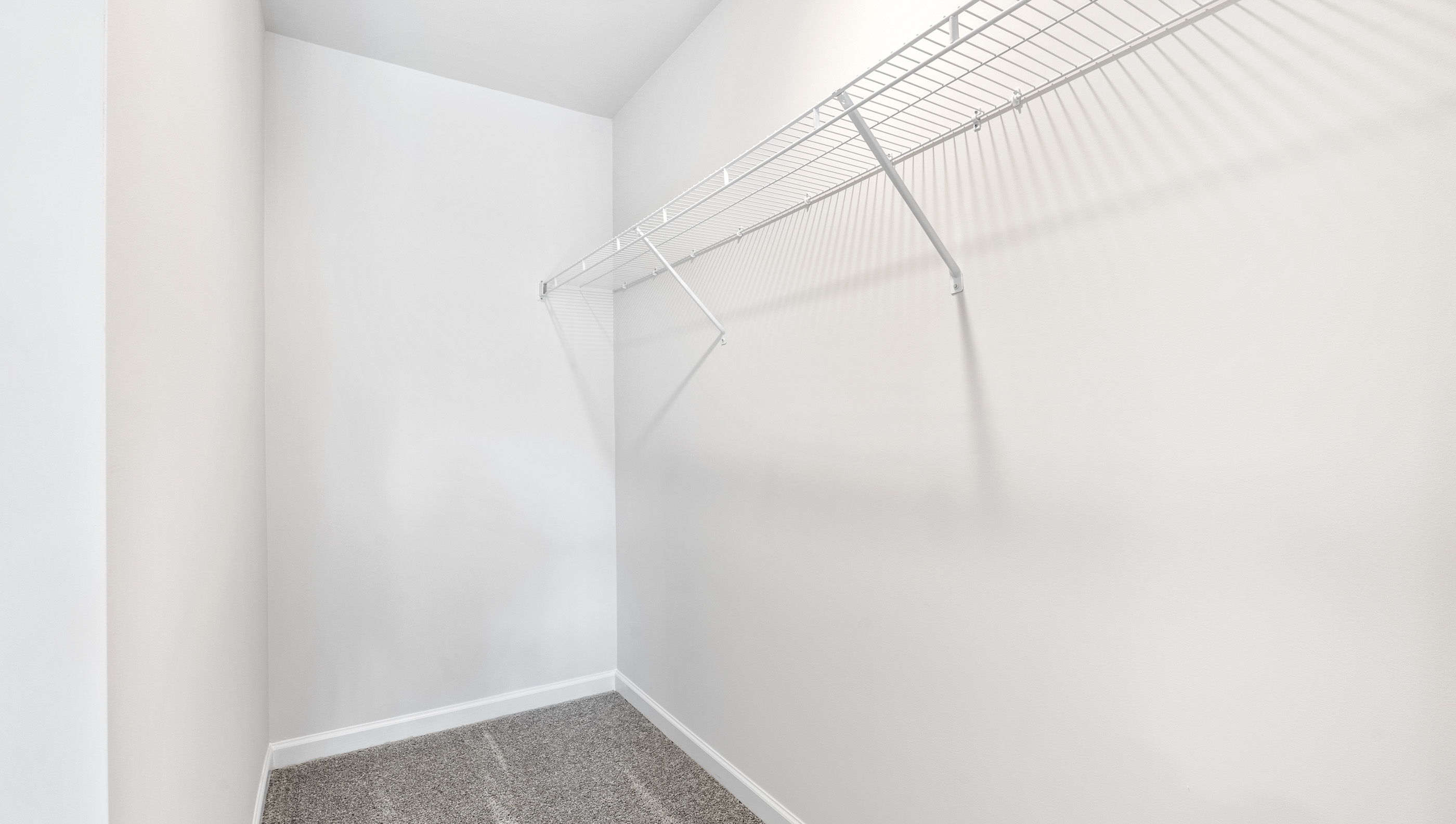 Walk in closet with shelves.