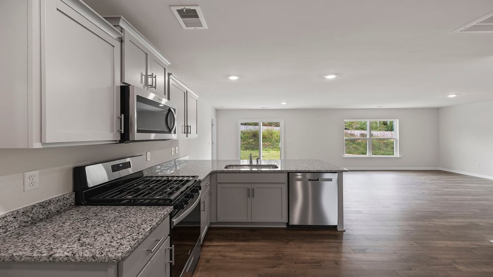 Kitchen with granite countertops and stainless steel appliances.