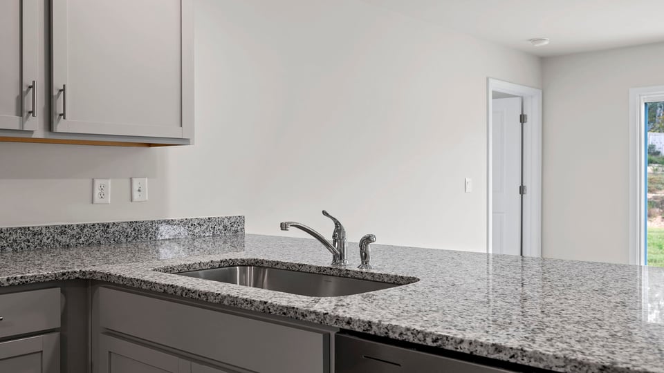 Kitchen with granite countertops and stainless steel appliances.