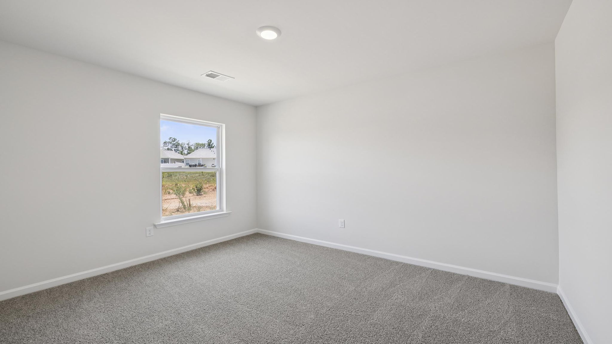 Bedroom with carpet and window.