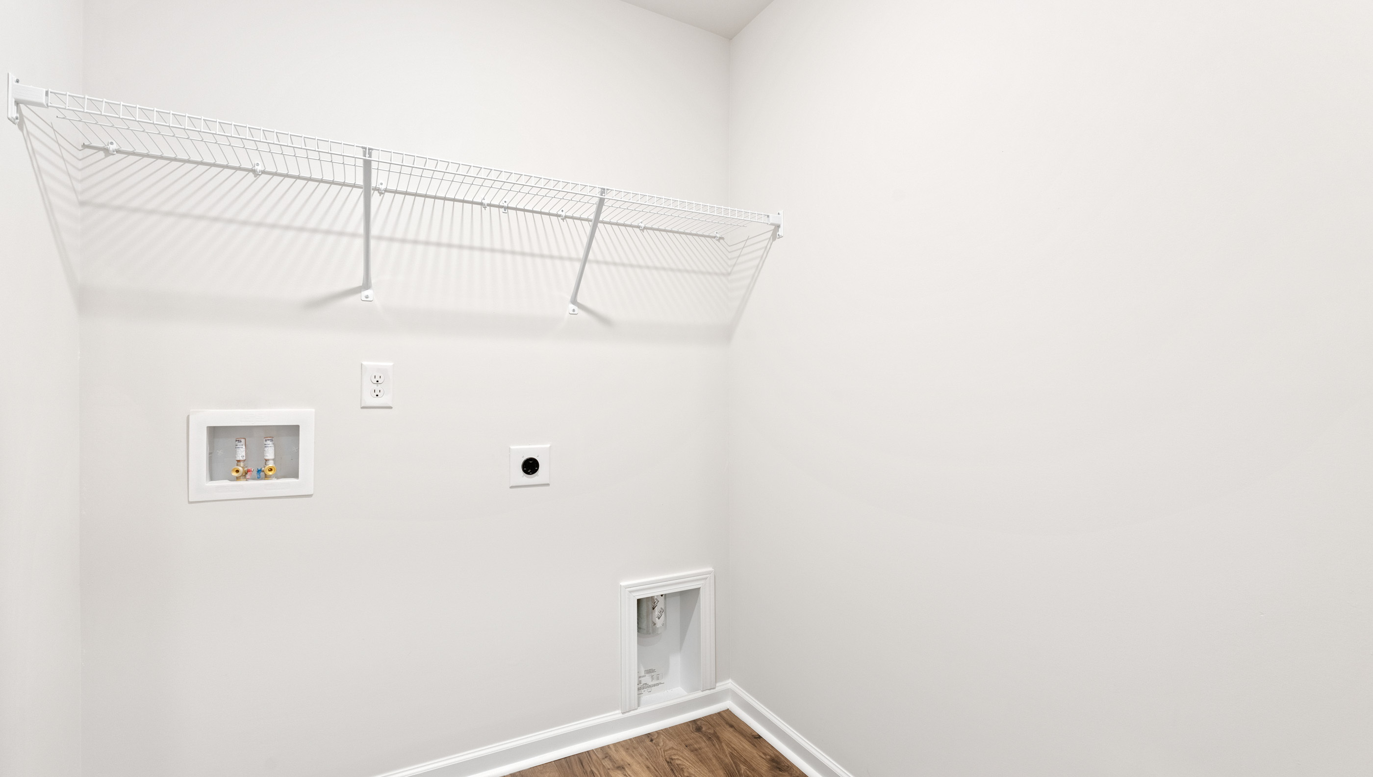 Walk in laundry with shelves.