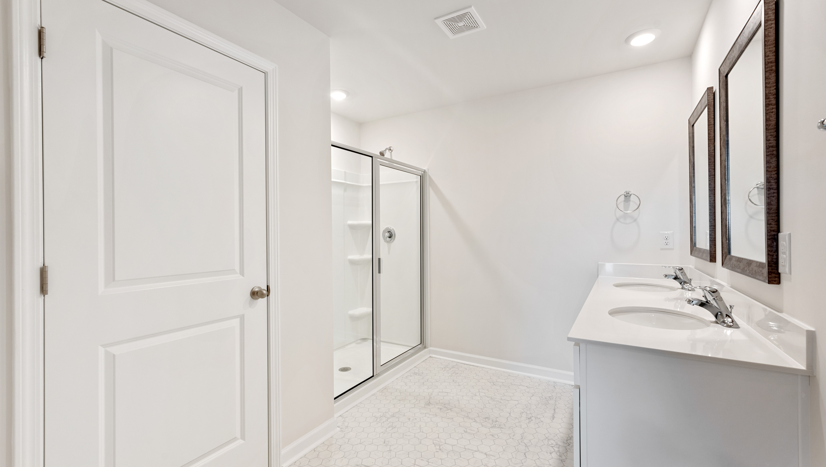 Bathroom with vanity and walk in shower.